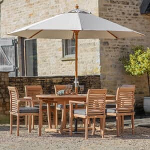 Bramblecrest Richmond 180 x 110cm Oval Dining Table with 6 Stacking Armchairs Seat Cushions Parasol And Base
